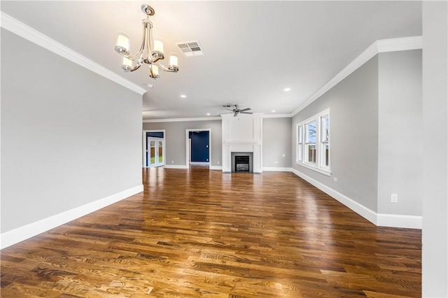 unfurnished living room with ceiling fan with notable chandelier, dark hardwood / wood-style flooring, and ornamental molding