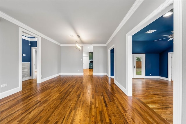 spare room featuring ceiling fan with notable chandelier, ornamental molding, and dark wood-type flooring