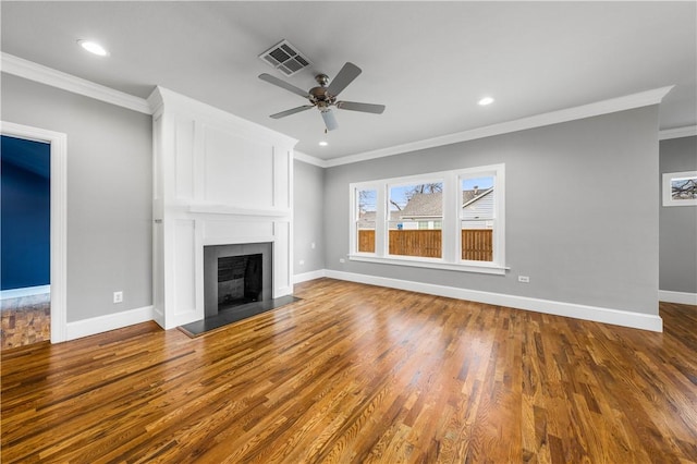 unfurnished living room featuring ceiling fan, wood-type flooring, and ornamental molding