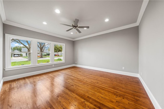 spare room featuring ceiling fan, wood-type flooring, and ornamental molding