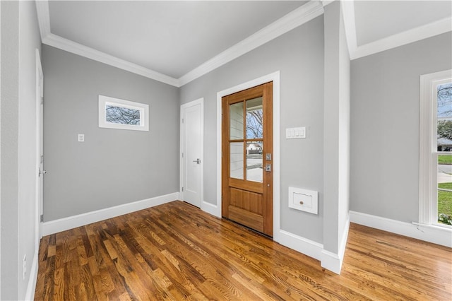 foyer with hardwood / wood-style flooring and ornamental molding