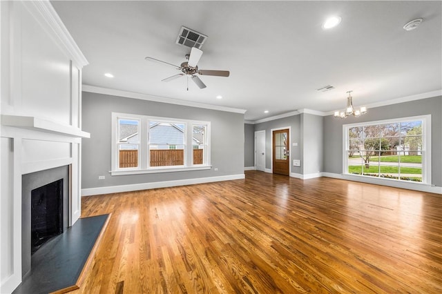 unfurnished living room with light hardwood / wood-style floors, ceiling fan with notable chandelier, and ornamental molding