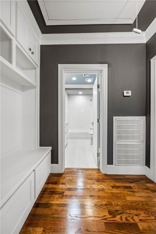 mudroom featuring dark hardwood / wood-style flooring and ornamental molding