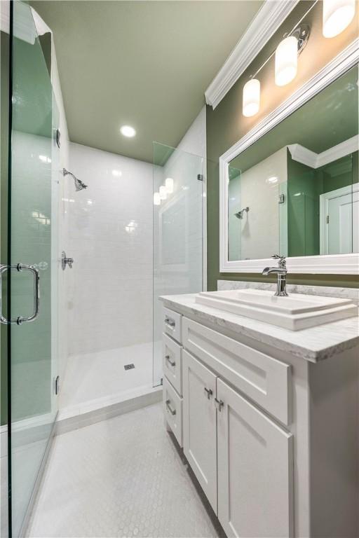 bathroom featuring vanity and an enclosed shower