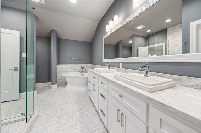 bathroom featuring tile patterned flooring, vanity, independent shower and bath, and lofted ceiling