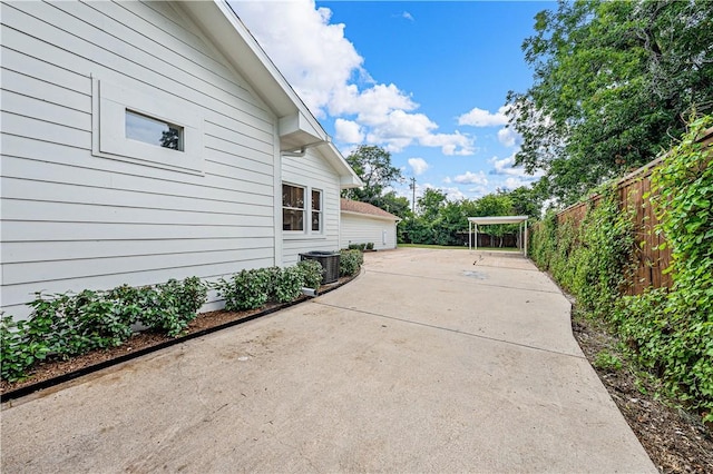 view of side of home with a patio and central AC unit