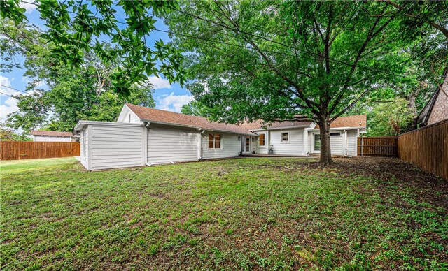 rear view of house with a yard