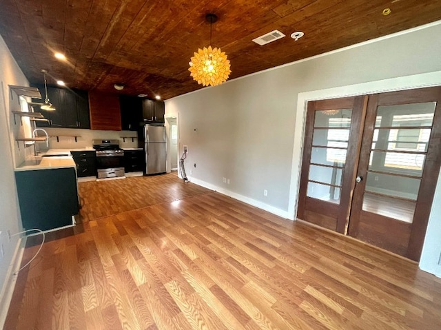 kitchen with visible vents, light wood-style flooring, appliances with stainless steel finishes, light countertops, and a sink