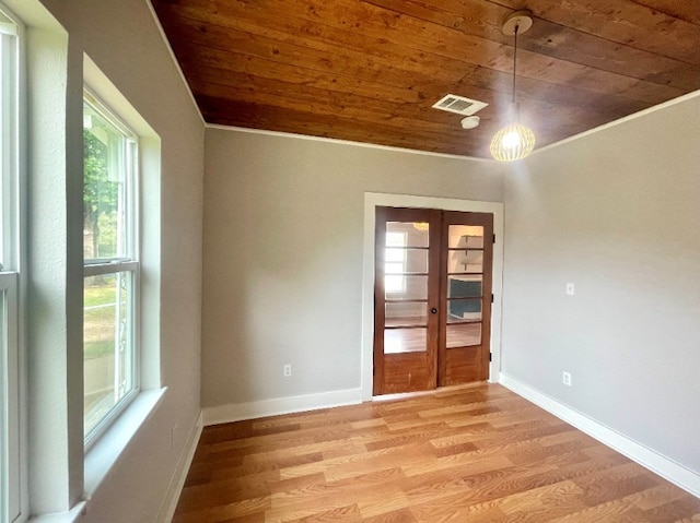 spare room featuring french doors, visible vents, light wood-style flooring, wooden ceiling, and baseboards