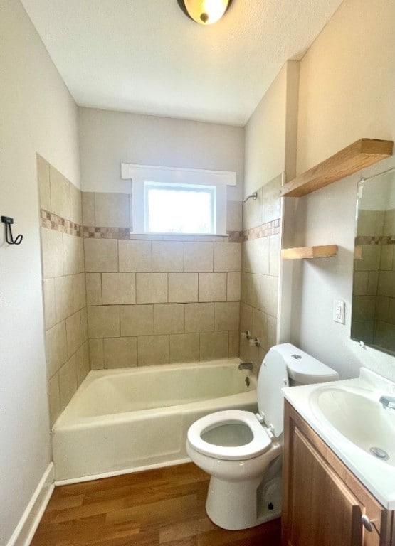 full bathroom with toilet, shower / bathtub combination, wood finished floors, and vanity