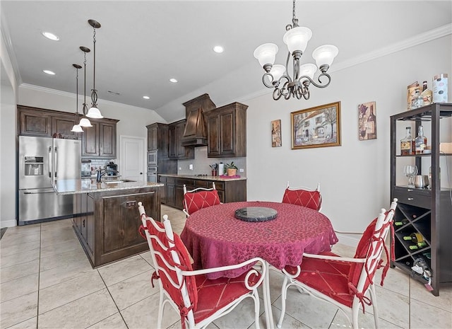 dining room featuring a notable chandelier, ornamental molding, sink, and light tile patterned floors