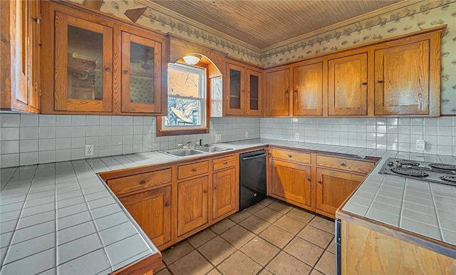 kitchen with tile counters, sink, decorative backsplash, and black dishwasher