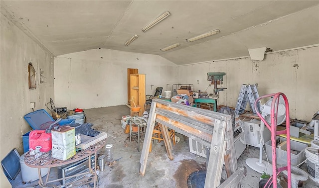 miscellaneous room with concrete flooring and vaulted ceiling