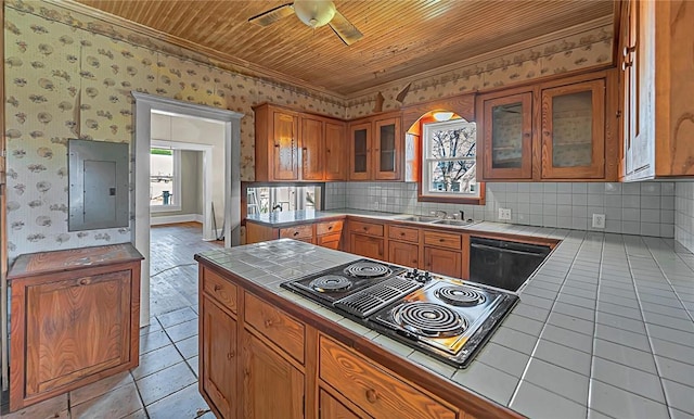 kitchen featuring tile counters, ceiling fan, wood ceiling, and electric panel