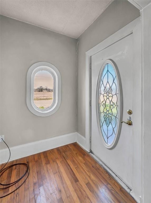 entrance foyer featuring a textured ceiling and hardwood / wood-style flooring