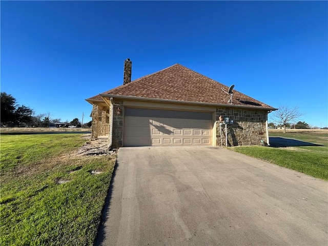 view of front of house with a garage and a front lawn