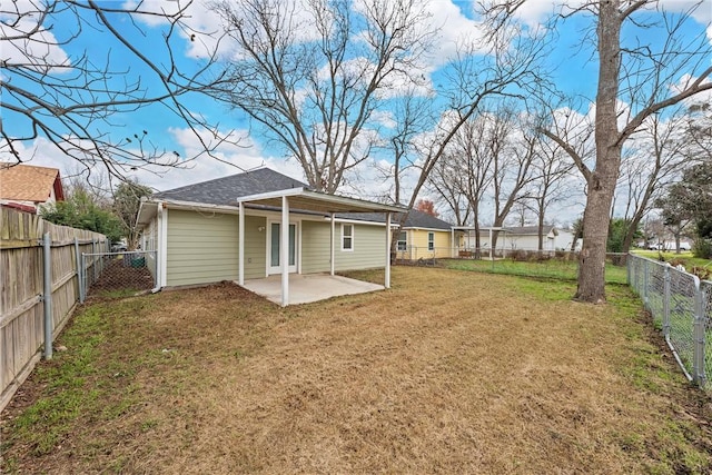 back of house featuring a patio and a lawn