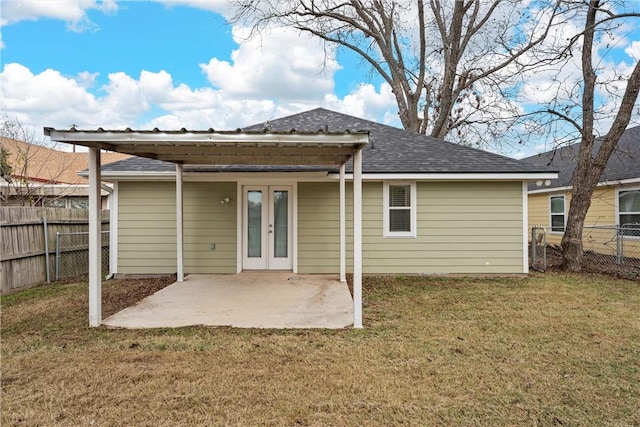 rear view of house featuring a lawn, a patio area, and french doors