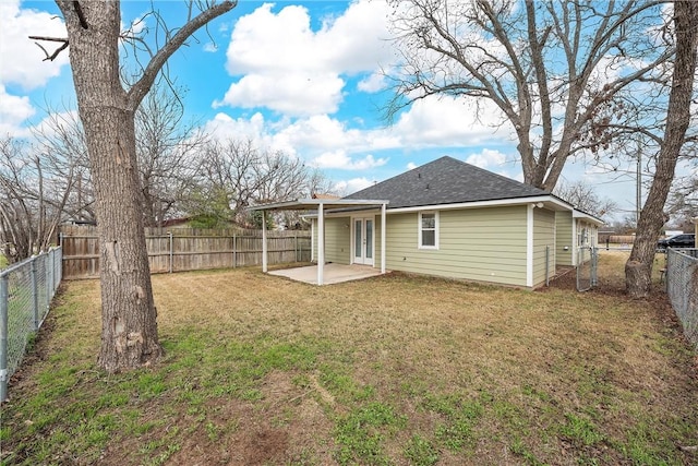 back of property with a patio area, a yard, and french doors