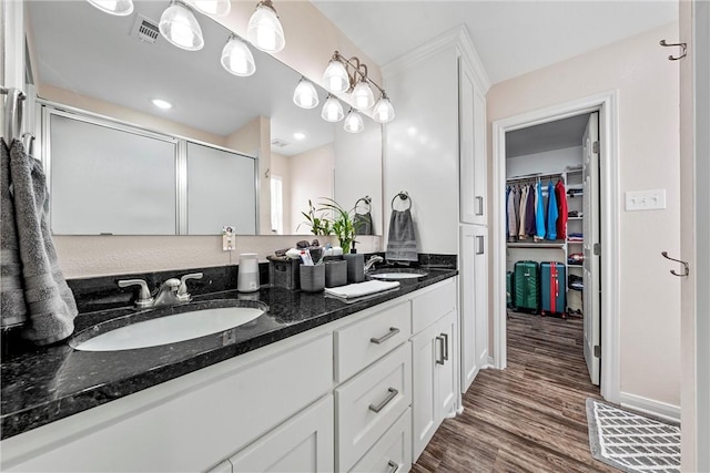 bathroom featuring vanity, a shower with shower door, and hardwood / wood-style flooring