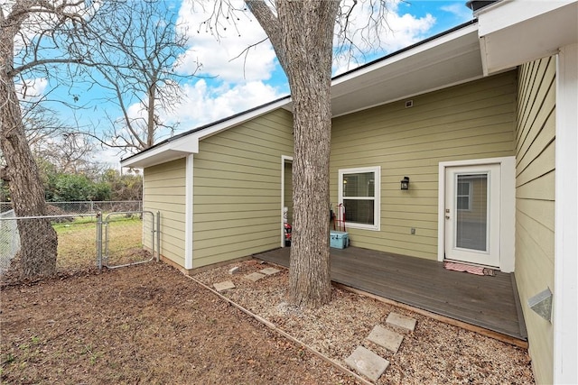 rear view of house featuring a wooden deck