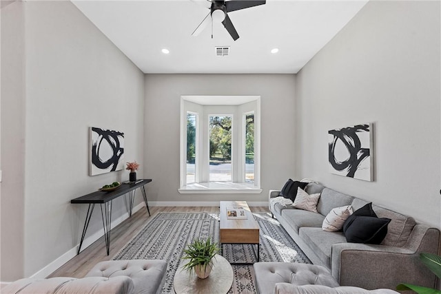 living room featuring ceiling fan and light hardwood / wood-style flooring