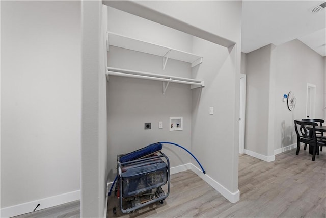 washroom featuring hookup for a washing machine, light hardwood / wood-style flooring, and electric dryer hookup