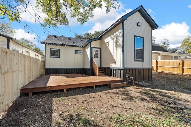 rear view of property featuring a deck