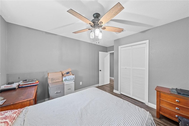 bedroom featuring ceiling fan, a closet, and dark hardwood / wood-style floors