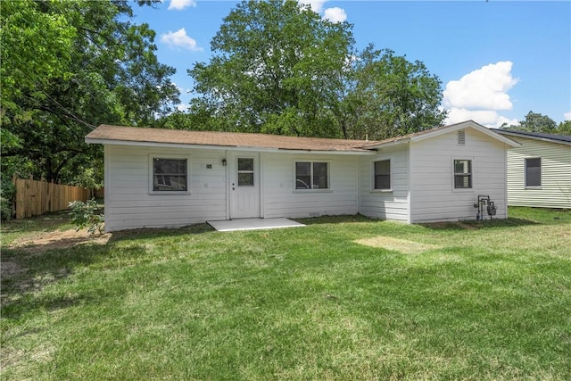 back of house featuring a yard