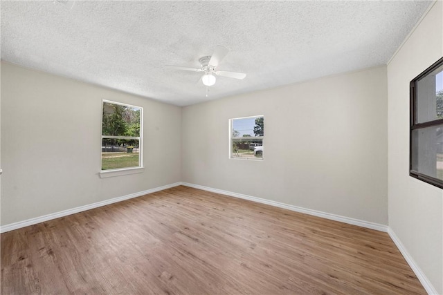 spare room featuring hardwood / wood-style floors, a textured ceiling, and ceiling fan