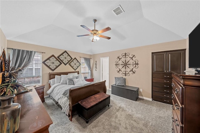 carpeted bedroom with ceiling fan and vaulted ceiling