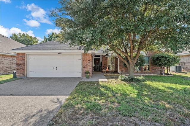 view of front of property with a garage, a front lawn, and central air condition unit