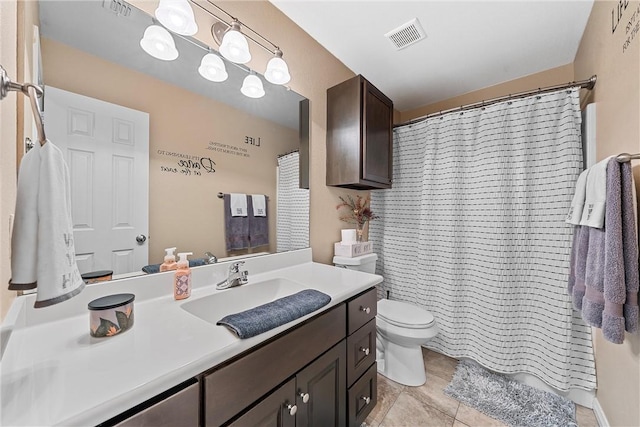 bathroom featuring tile patterned flooring, vanity, a shower with shower curtain, and toilet