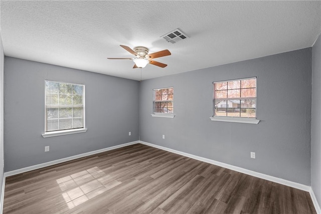 spare room featuring ceiling fan, a textured ceiling, and hardwood / wood-style flooring