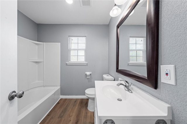 full bathroom featuring shower / tub combination, vanity, hardwood / wood-style flooring, and toilet