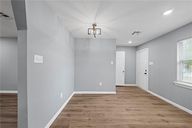 foyer featuring light hardwood / wood-style flooring and a chandelier