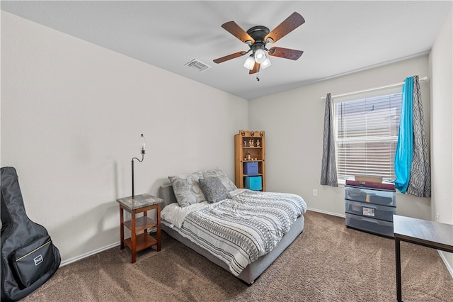 bedroom with ceiling fan and dark carpet