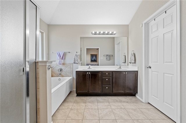 bathroom featuring a bath, vanity, and tile patterned floors