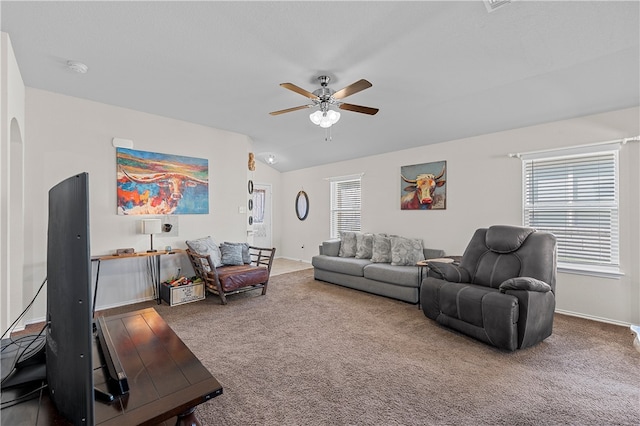 carpeted living room with ceiling fan, a healthy amount of sunlight, and vaulted ceiling