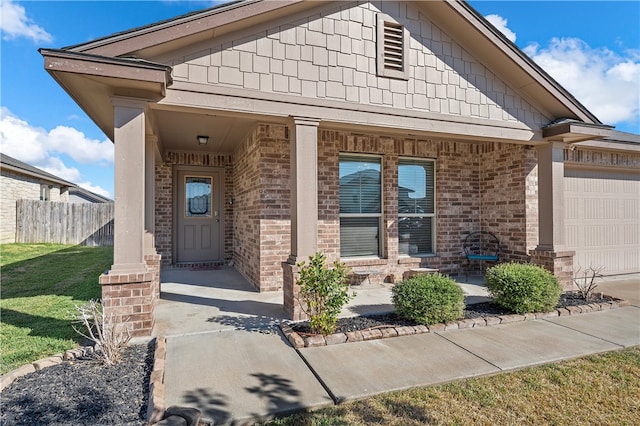 doorway to property featuring covered porch and a garage