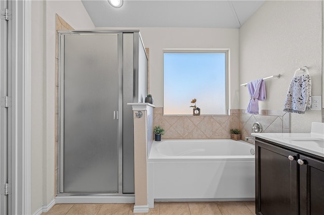 bathroom with tile patterned floors, separate shower and tub, and lofted ceiling