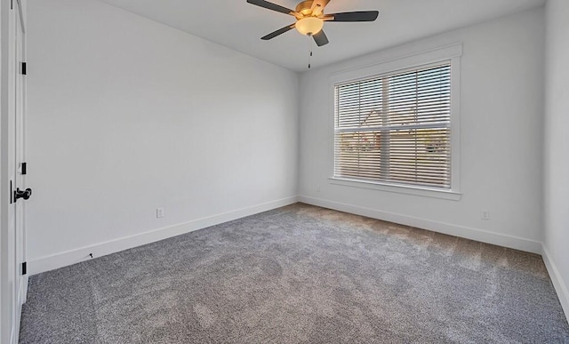 carpeted spare room featuring ceiling fan