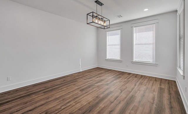 unfurnished dining area featuring dark wood-type flooring