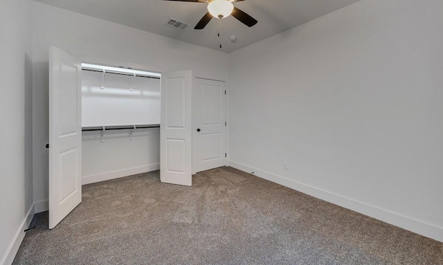 unfurnished bedroom featuring carpet, a closet, and ceiling fan