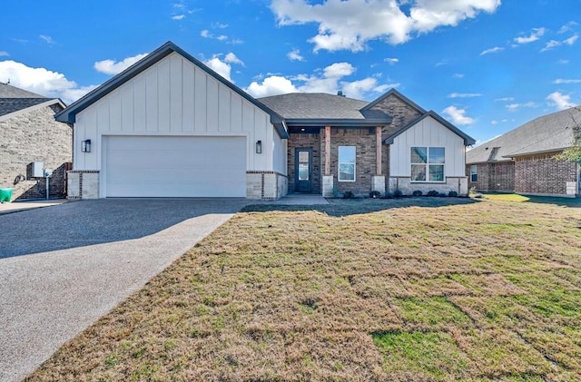 view of front facade with a front yard and a garage