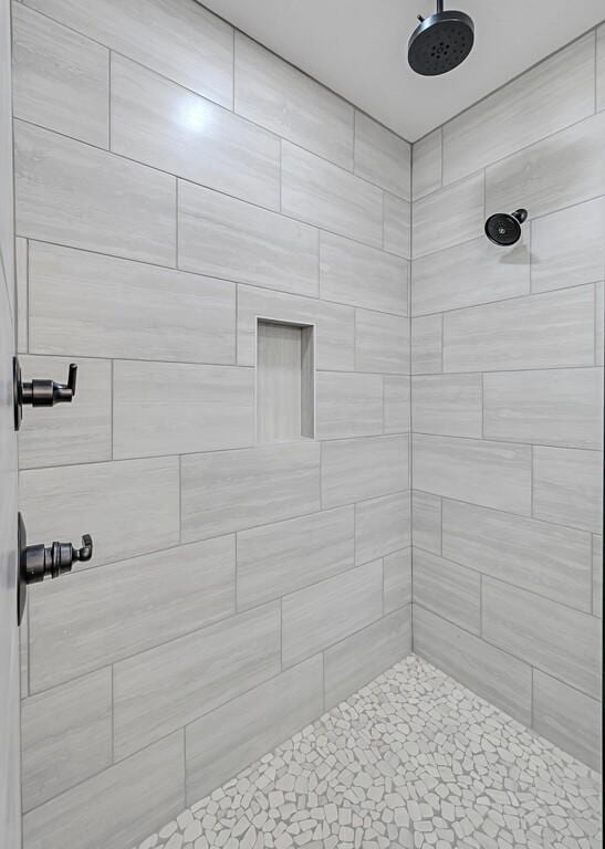 bathroom with tiled shower