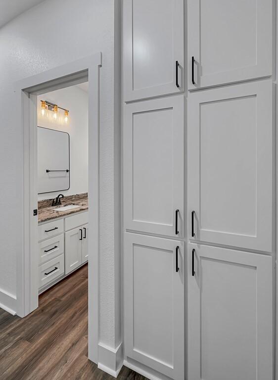 room details featuring hardwood / wood-style flooring and sink