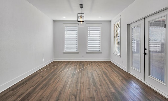 unfurnished dining area featuring french doors and dark hardwood / wood-style floors