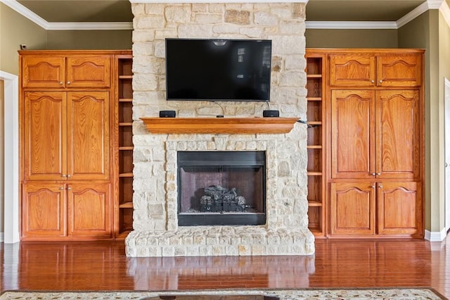 unfurnished living room with a fireplace, hardwood / wood-style flooring, and ornamental molding